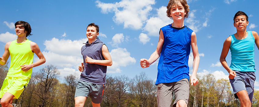 young men running outside in athletic wear